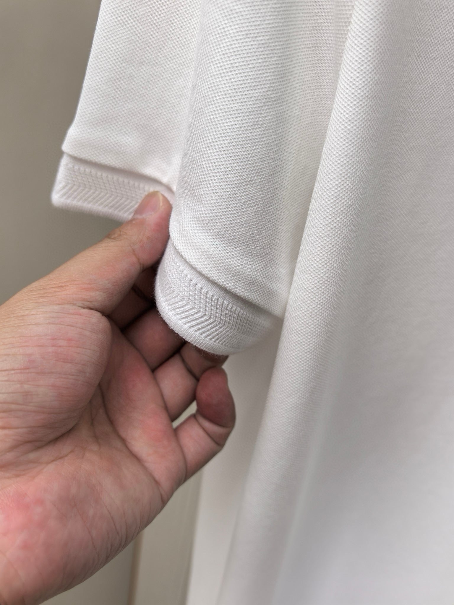 White polo shirt sleeve hem with ribbed cuff detail