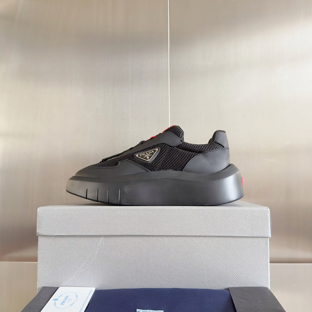 Prada unisex low-top sneakers, dark gray mesh upper, thick sole, black and red accents