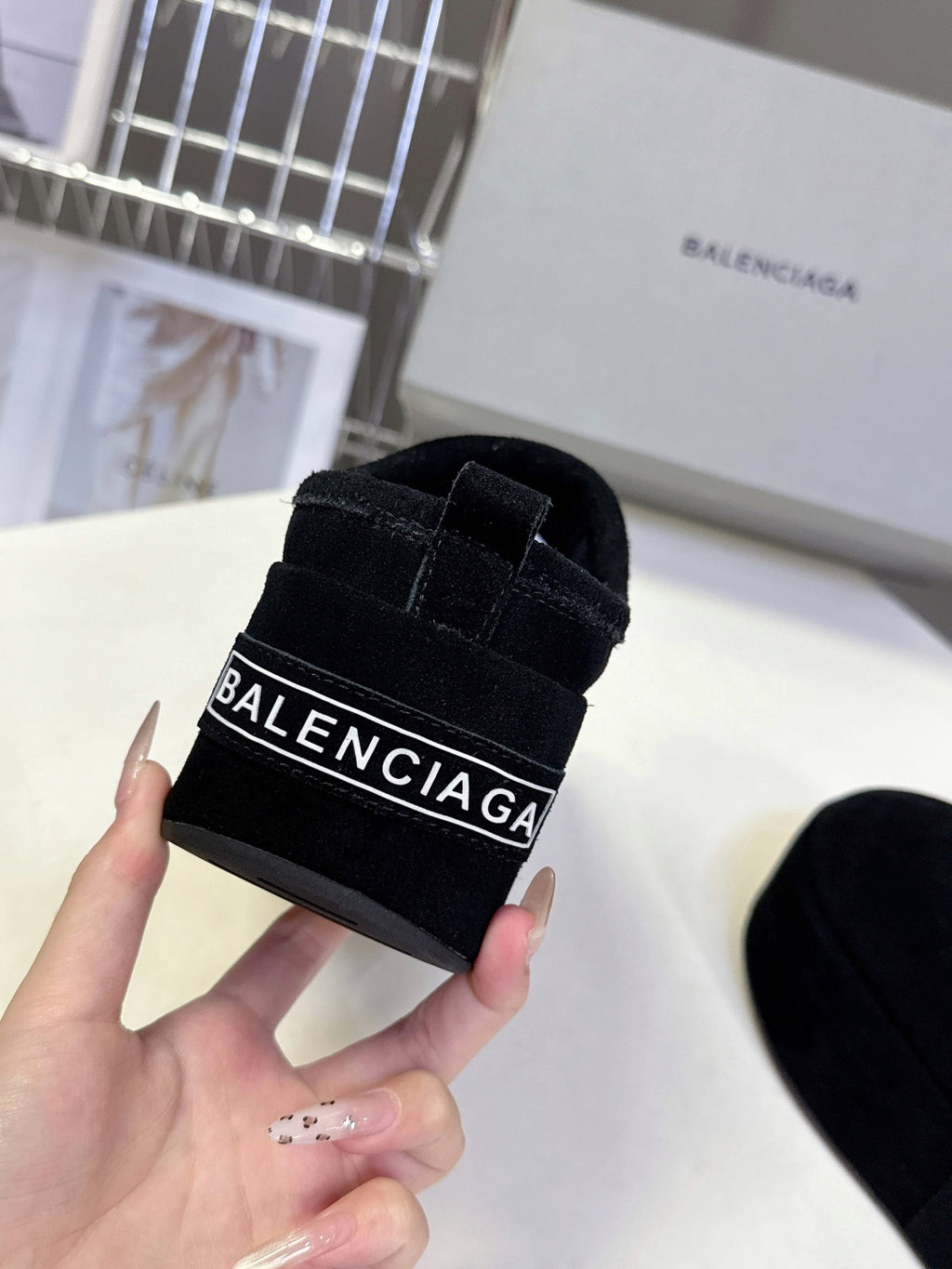 Balenciaga black suede slip-on sandal close-up with black strap logo patch