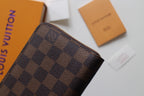 Louis Vuitton small bag close-up of Damier check pattern canvas.