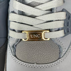 Gray sneaker lace strap with gold UNC tag and white eyelets