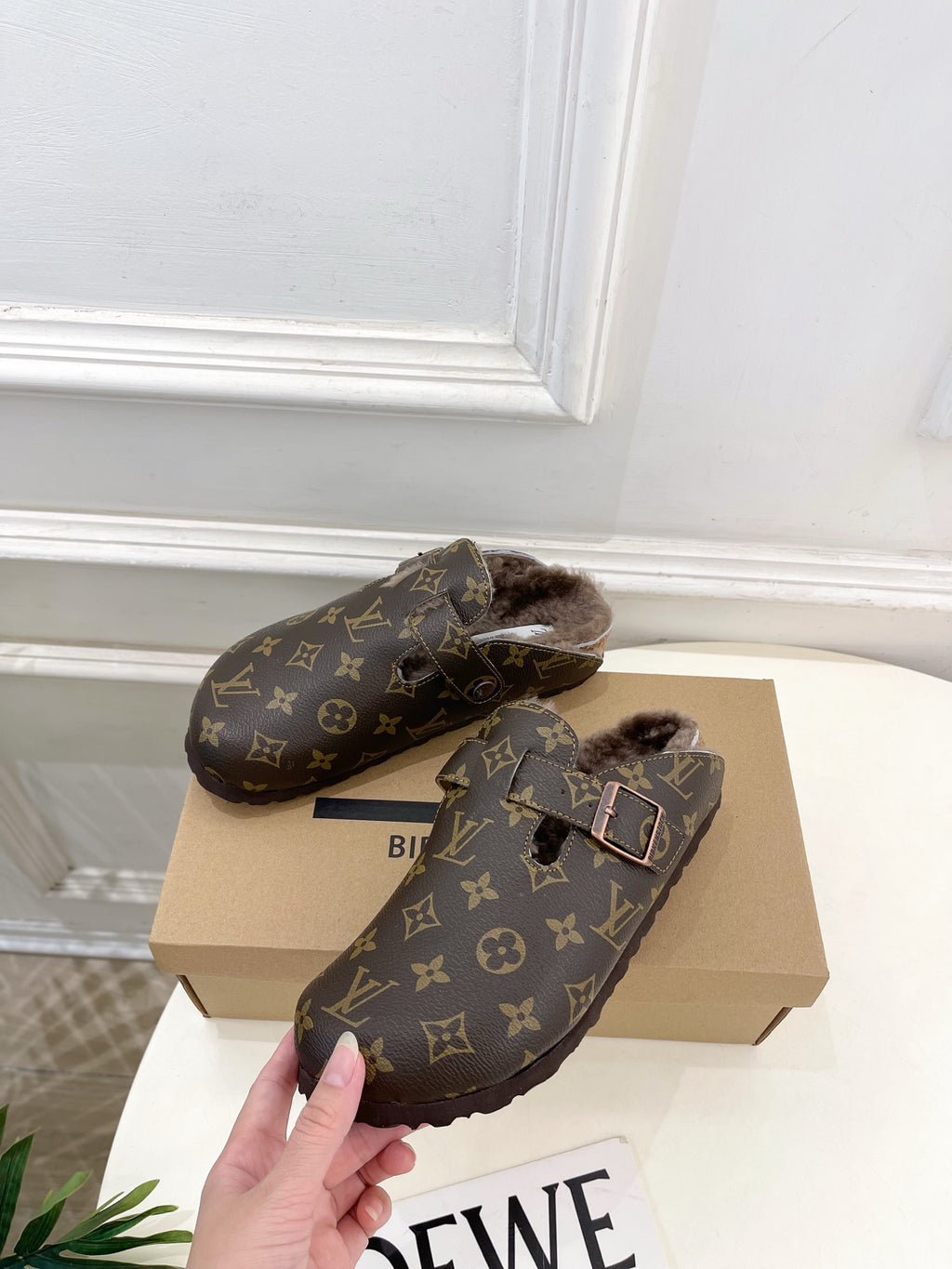 Louis Vuitton monogram clogs with two straps, buckles, and faux-fur lining