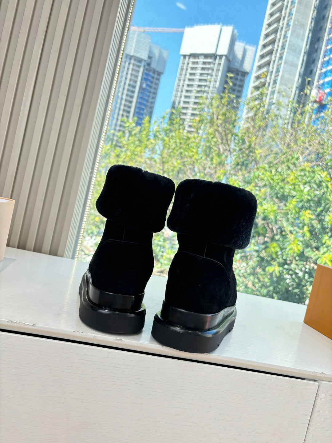 Black Louis Vuitton unisex ankle boots rear view with cushioned fur cuff