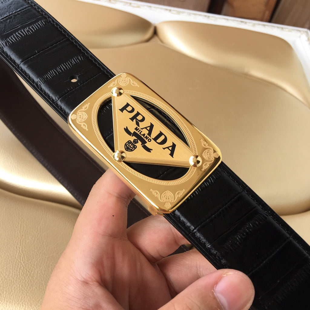 Black leather belt with gold-tone Prada buckle and engraved gold frame