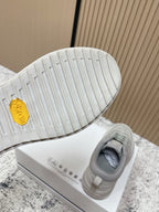 Light gray sneaker outsole with textured tread and gold Moncler hex logo
