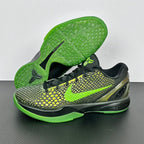Black and green basketball shoes with lime outsole, textured upper, and neon lace detail.