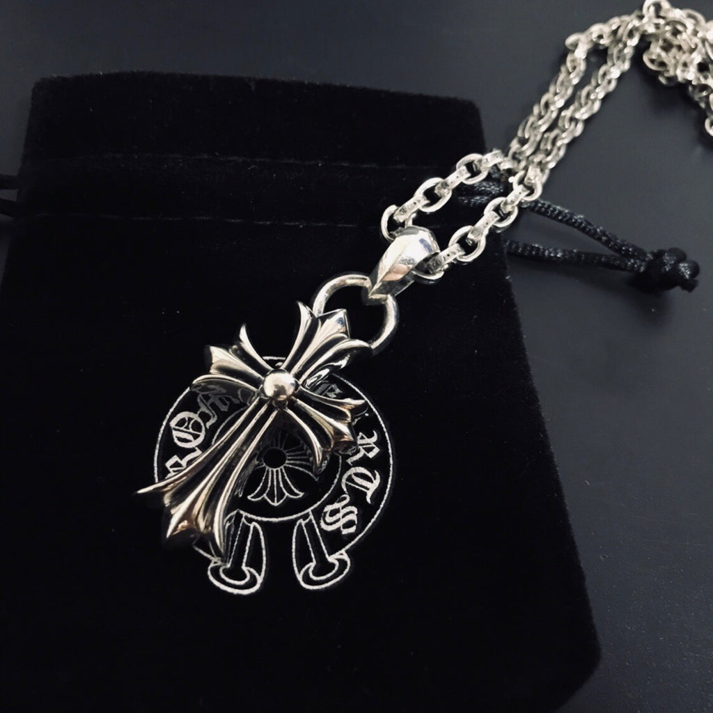 Silver cross pendant necklace with linked chain and black cord pull tab
