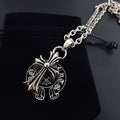 Silver cross pendant necklace with linked chain and black cord pull tab