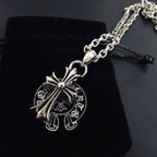 Silver cross pendant necklace with linked chain and black cord pull tab