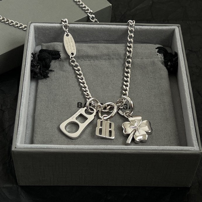 Balenciaga silver pendant necklace in box with clover, BB, and keyhole charms