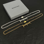 Silver and gold Balenciaga logo chain necklace set with clasps, in flat lay