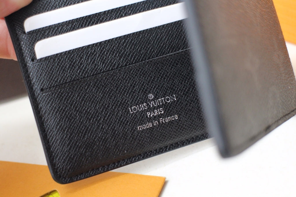 Louis Vuitton small bag, black leather card holder interior with stamped logo