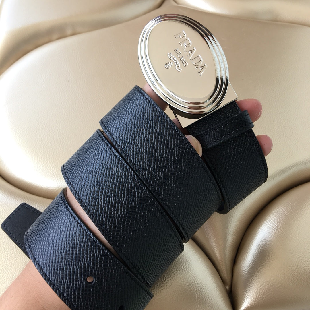 Prada belt laid flat showing dark strap, buckle end, and eyelet holes
