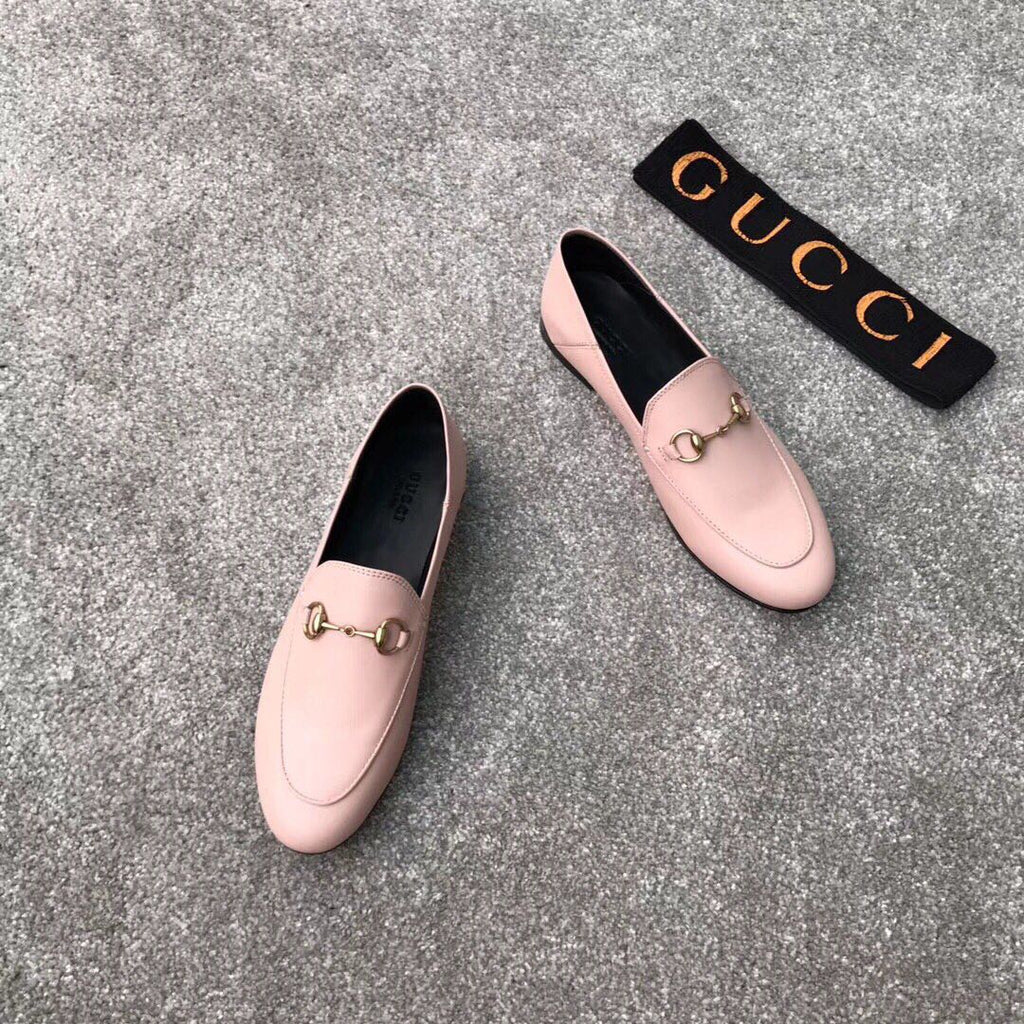 Pink Gucci loafers, front and side views, gold-tone bit accent, slip-on