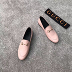Pink Gucci loafers, front and side views, gold-tone bit accent, slip-on