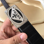 Prada belt with dark leather strap and silver PRADA logo buckle, metal rivets