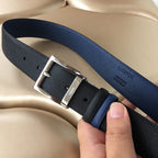 Two-tone belt with silver buckle and textured strap, blue edge and black underside