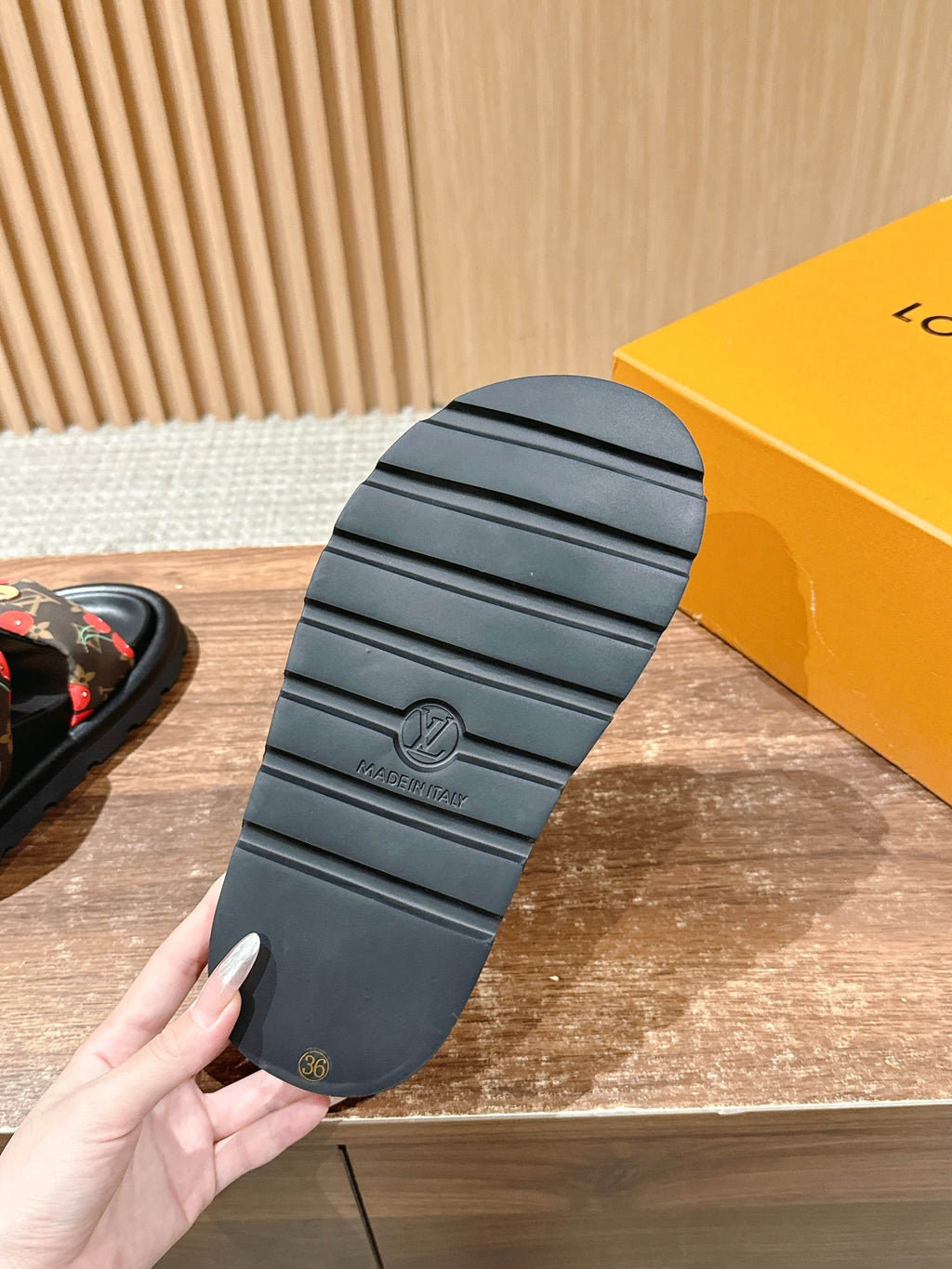 Louis Vuitton slide sandal outsole with ridged tread and brand mark