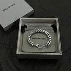 Silver chain bracelet in gift box with BALENCIAGA logo engraving and black tassel accents