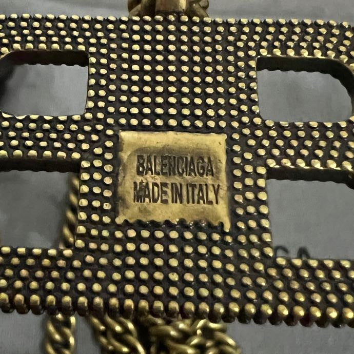 Balenciaga label on studded leather tag, gold-toned and dark strap detail
