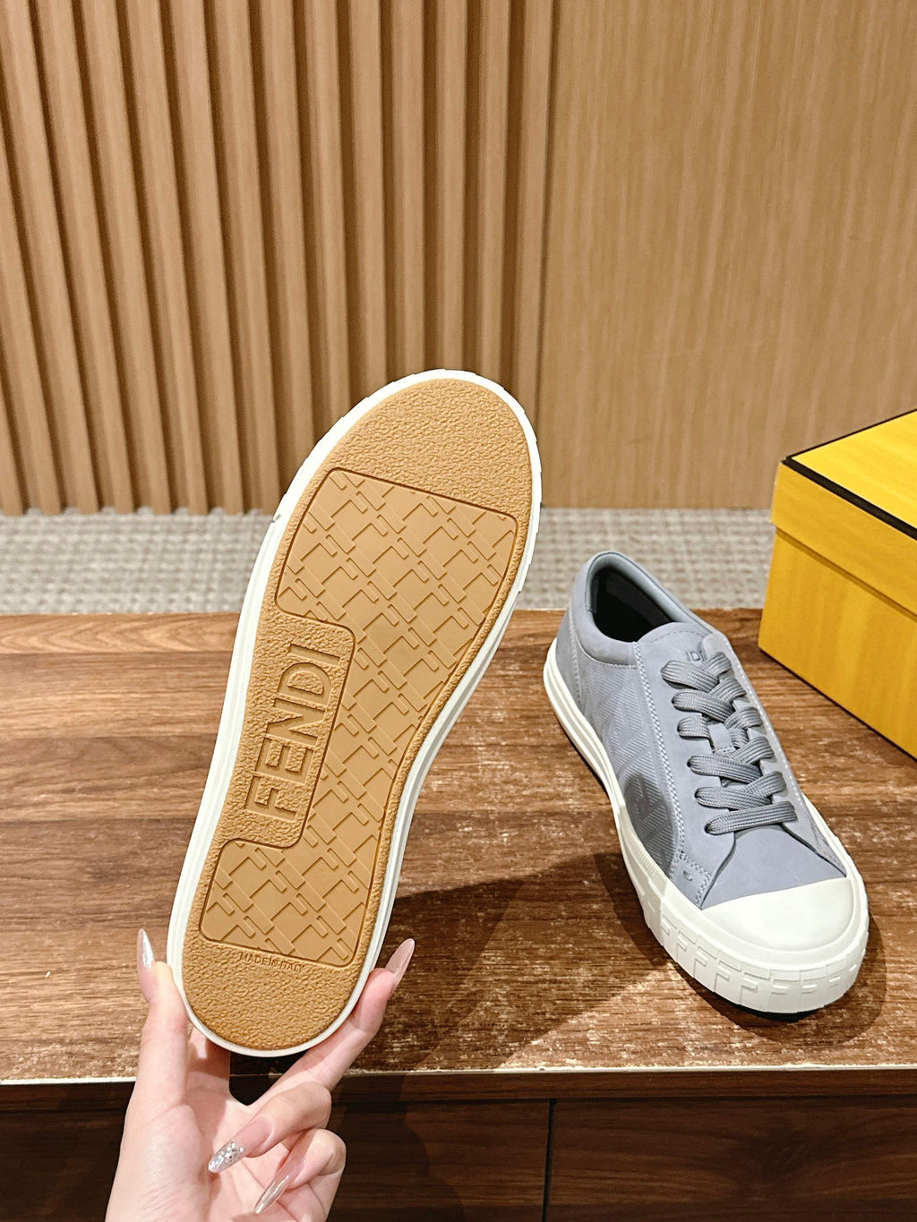 Gray FENDI sneakers with visible tan outsole texture and white sidewall logo