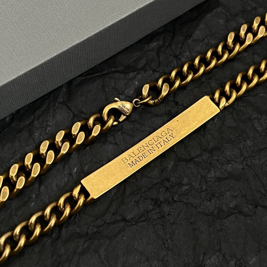 Balenciaga gold-tone chain accessory with "MADE IN ITALY" logo bar