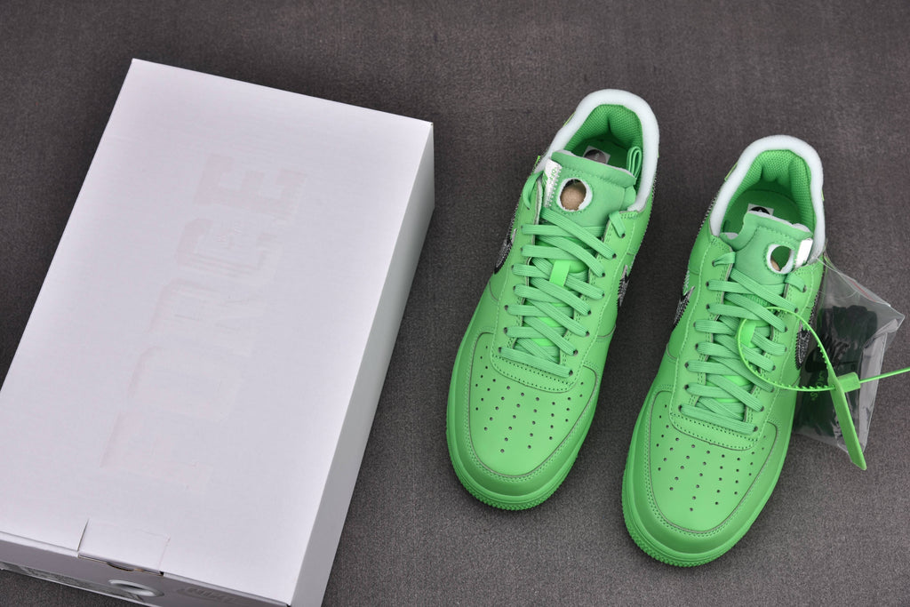Pair of green low-top sneakers with white soles, displayed with a white shoebox
