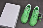 Pair of green low-top sneakers with white soles, displayed with a white shoebox