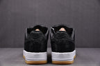 Black low-top sneakers with white midsoles and gum soles