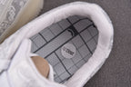 Close-up of white low-top sneakers inner sole with grid pattern branding
