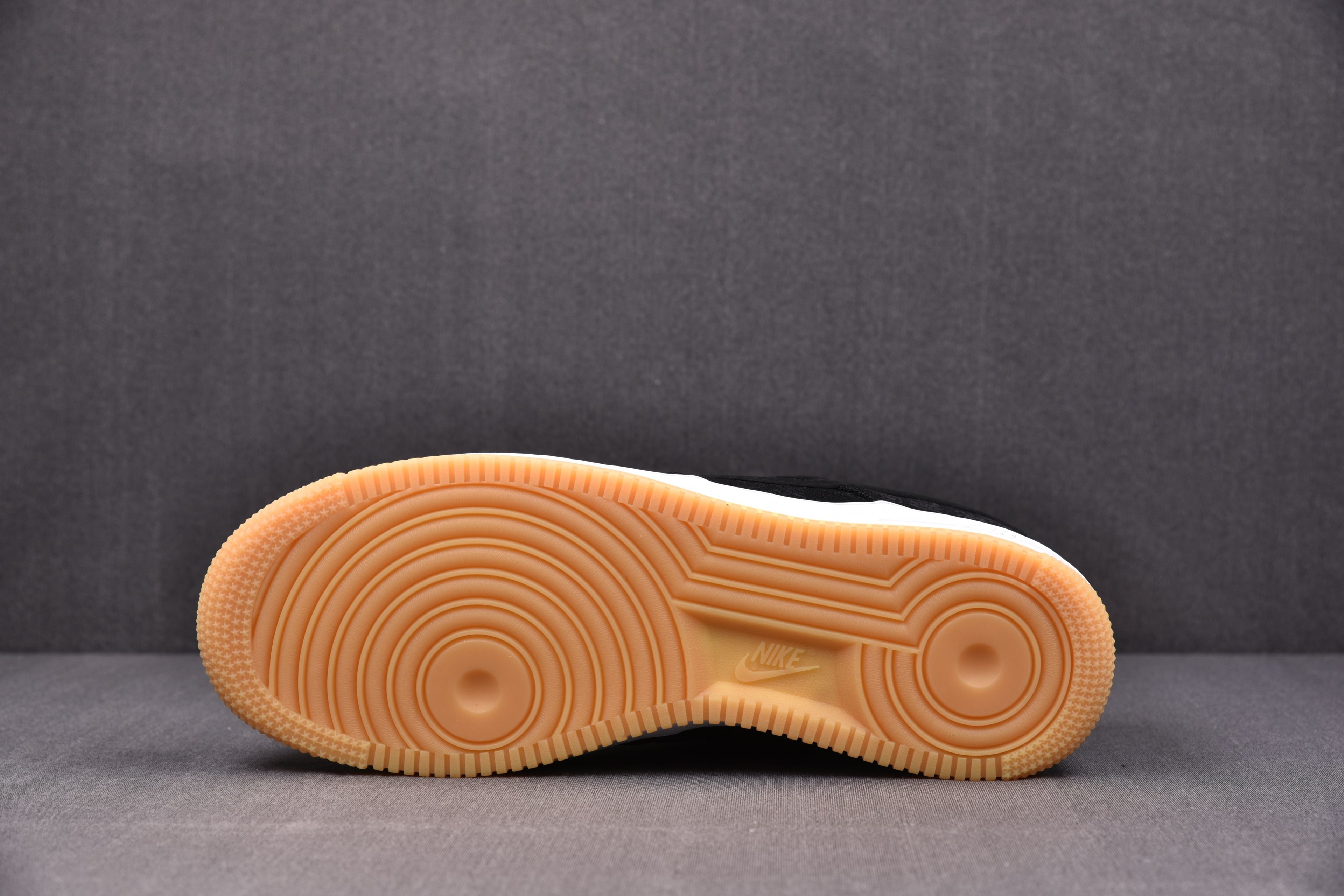 Tan rubber Air Force 1 outsole with circular tread pattern and traction grooves