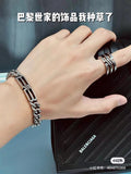 Stacked chain bracelets on wrist, silver-tone links with clasp detail