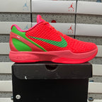 Red and green low-top basketball sneaker, side view, lace-up