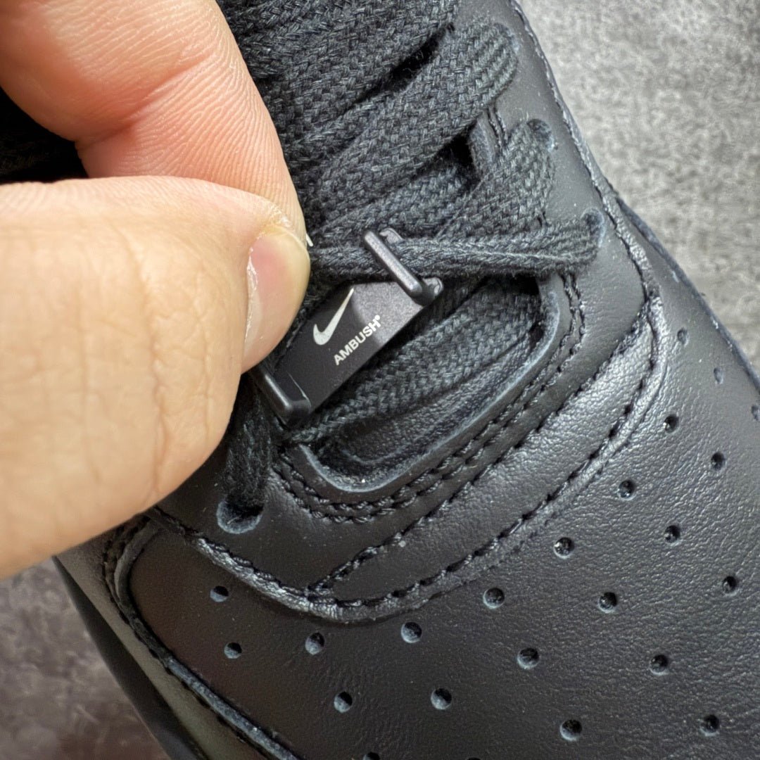 Black sneaker lace-up with small "AMBUSH" tag on tongue area