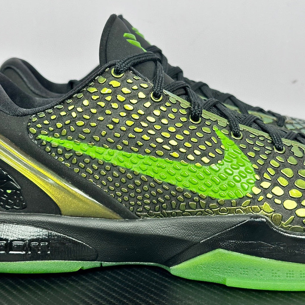 Black and green basketball shoe upper with neon laces, textured dots, and lime sole trim.