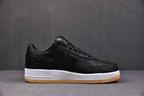 Black leather sneaker with Swoosh, embossed details, white midsole, gum outsole