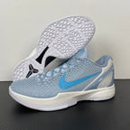 Light blue and gray basketball shoes with black traction star on white outsole, lace-up.