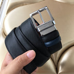 Prada belt close-up of dark textured strap with silver buckle and leather keeper
