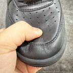Black leather sneaker toe with perforation detailing and stitched panel seam