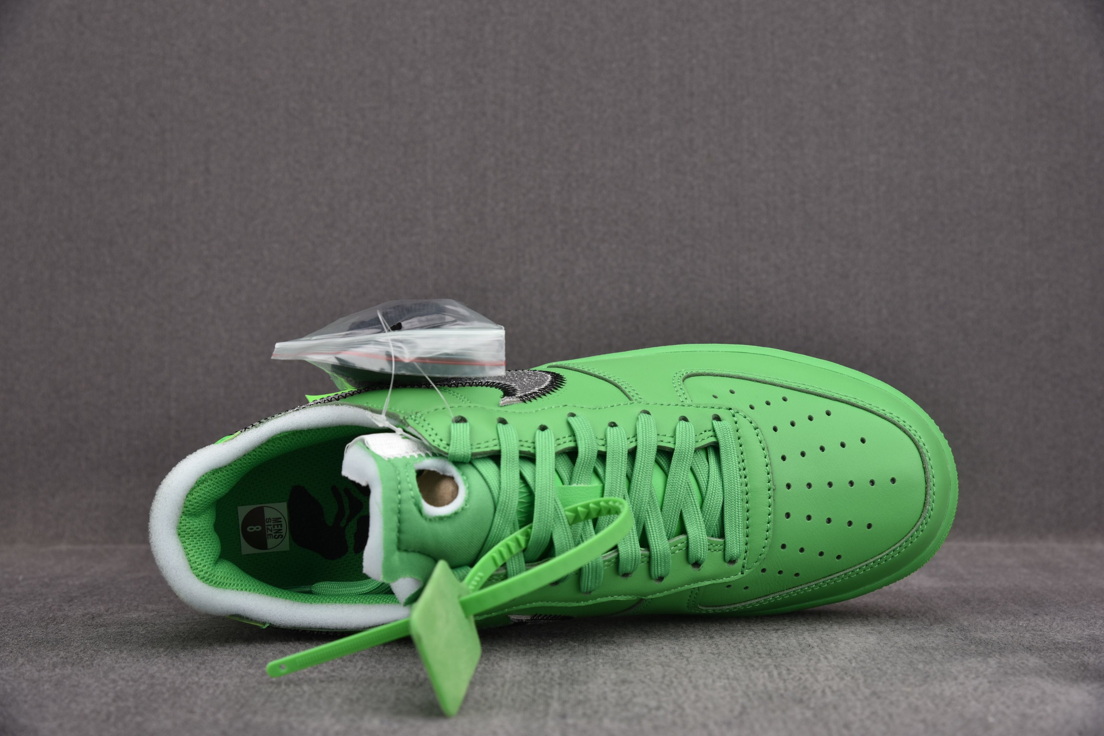 Bright green Air Force 1 low-top sneaker with lace-up eyelets and white lining