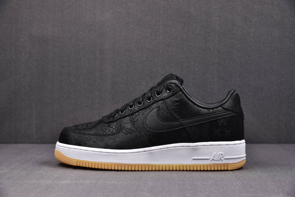 Black low-top sneaker with Swoosh, Air detail on midsole, white midsole, gum outsole