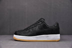Black low-top sneaker with Swoosh, Air detail on midsole, white midsole, gum outsole