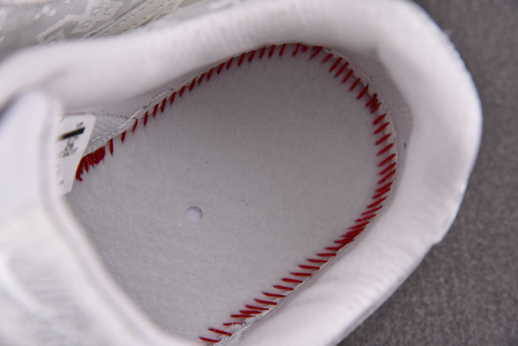 Sneaker interior lining with red stitched edge and gray footbed