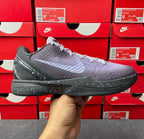 Basketball sneaker with dark gray and purple upper, lace-up front, black sole.