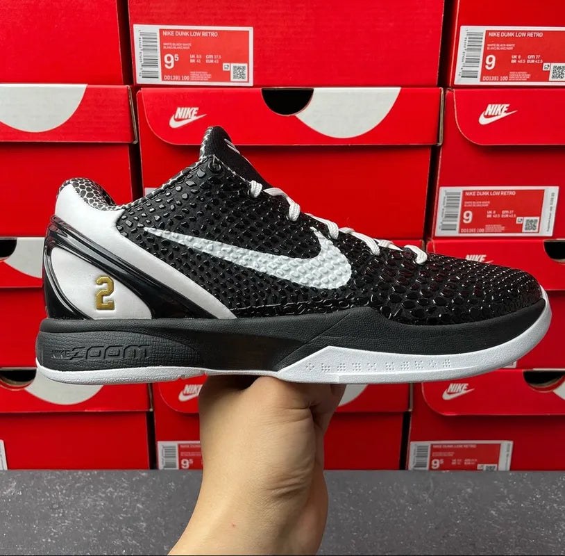 Black Nike basketball shoe with white swoosh, textured upper, and gray midsole