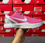 Pink knit basketball shoe with white swoosh and gray sole, side view.