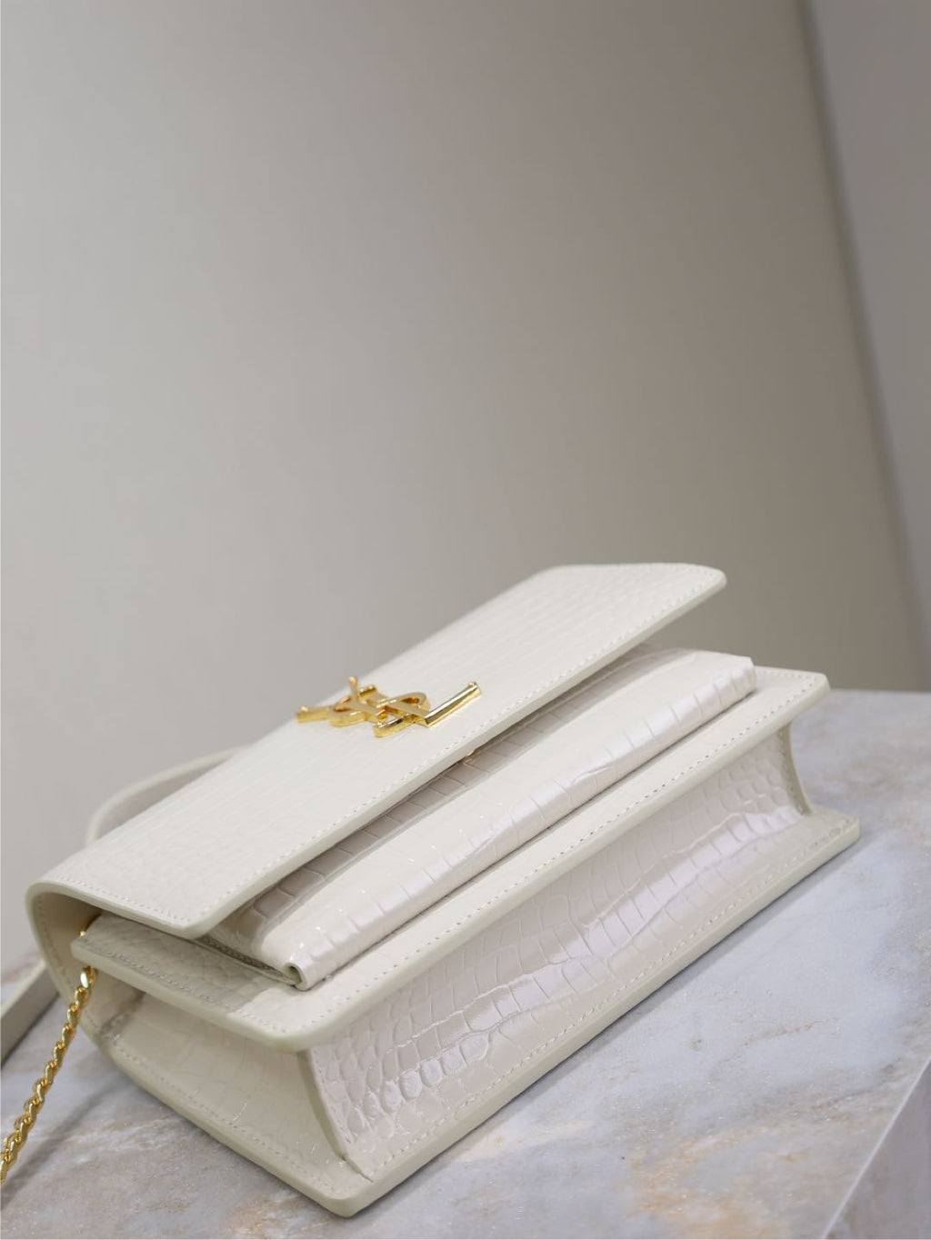 YSL bag, white crocodile-texture leather clutch style with flap and gold clasp