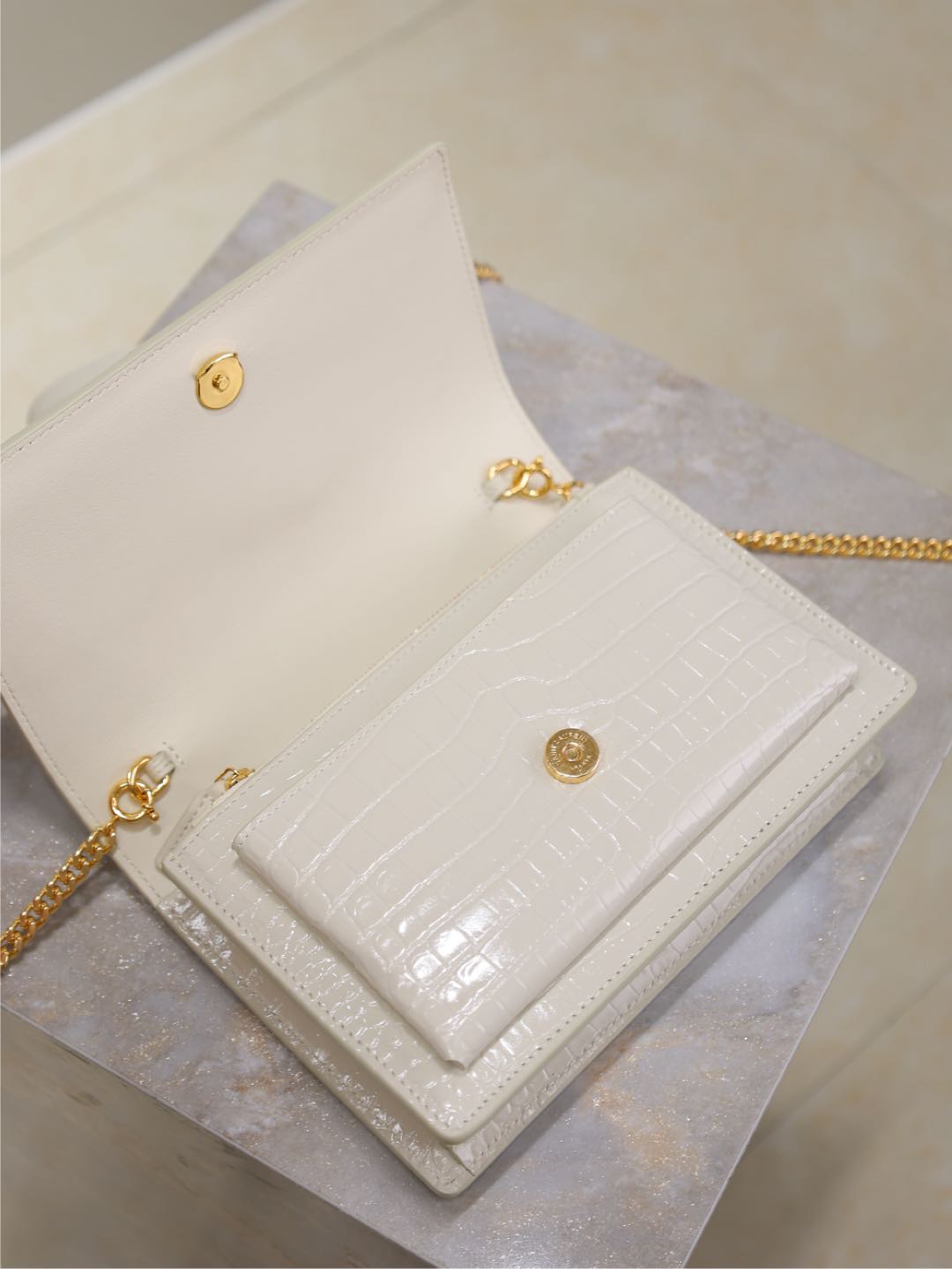 YSL bag, white croc-texture leather clutch with gold logo studs and chain