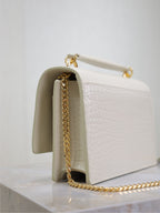 YSL bag, white croc-texture leather interior view with gold chain strap
