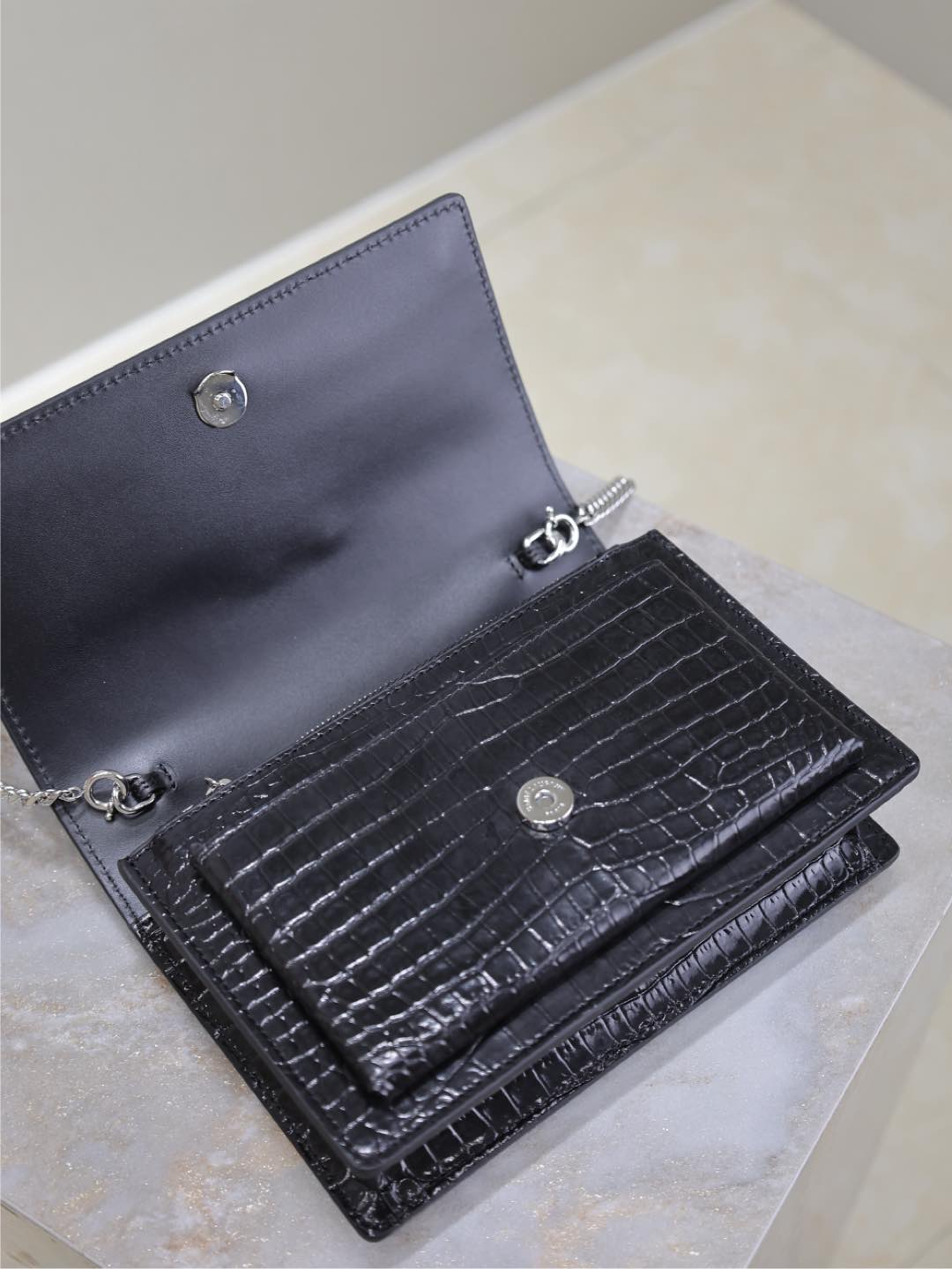 YSL croc-embossed wallet bag open view with snap closure and interior compartments.